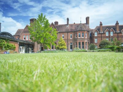 redbrick victorian buildings in garden setting with wide lawn