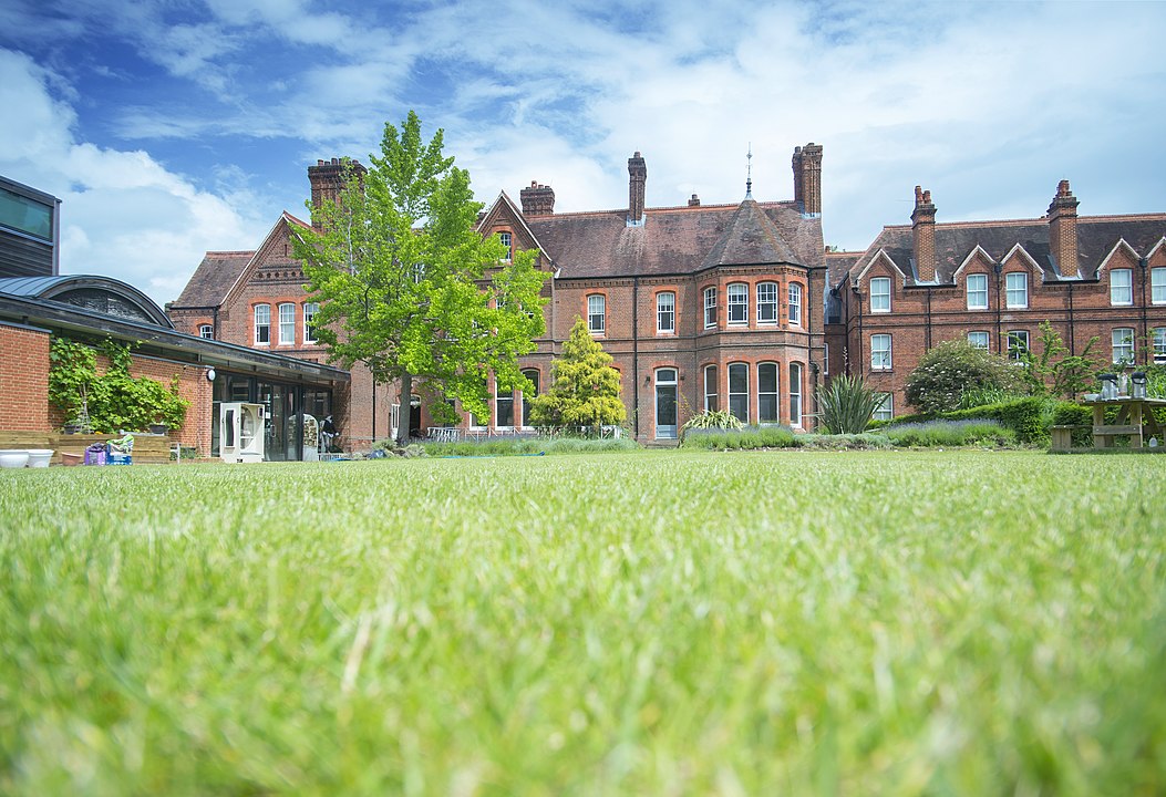 redbrick victorian buildings in garden setting with wide lawn