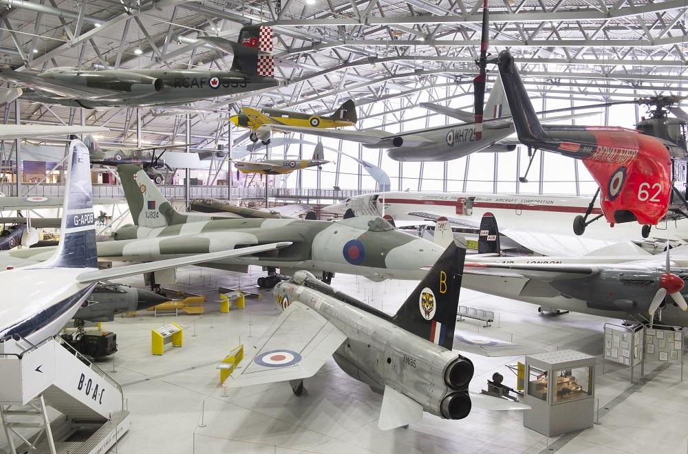 many historic aircraft hanging in hangar in museum