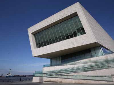 concrete exterior of the museum of liverpool against blue sky