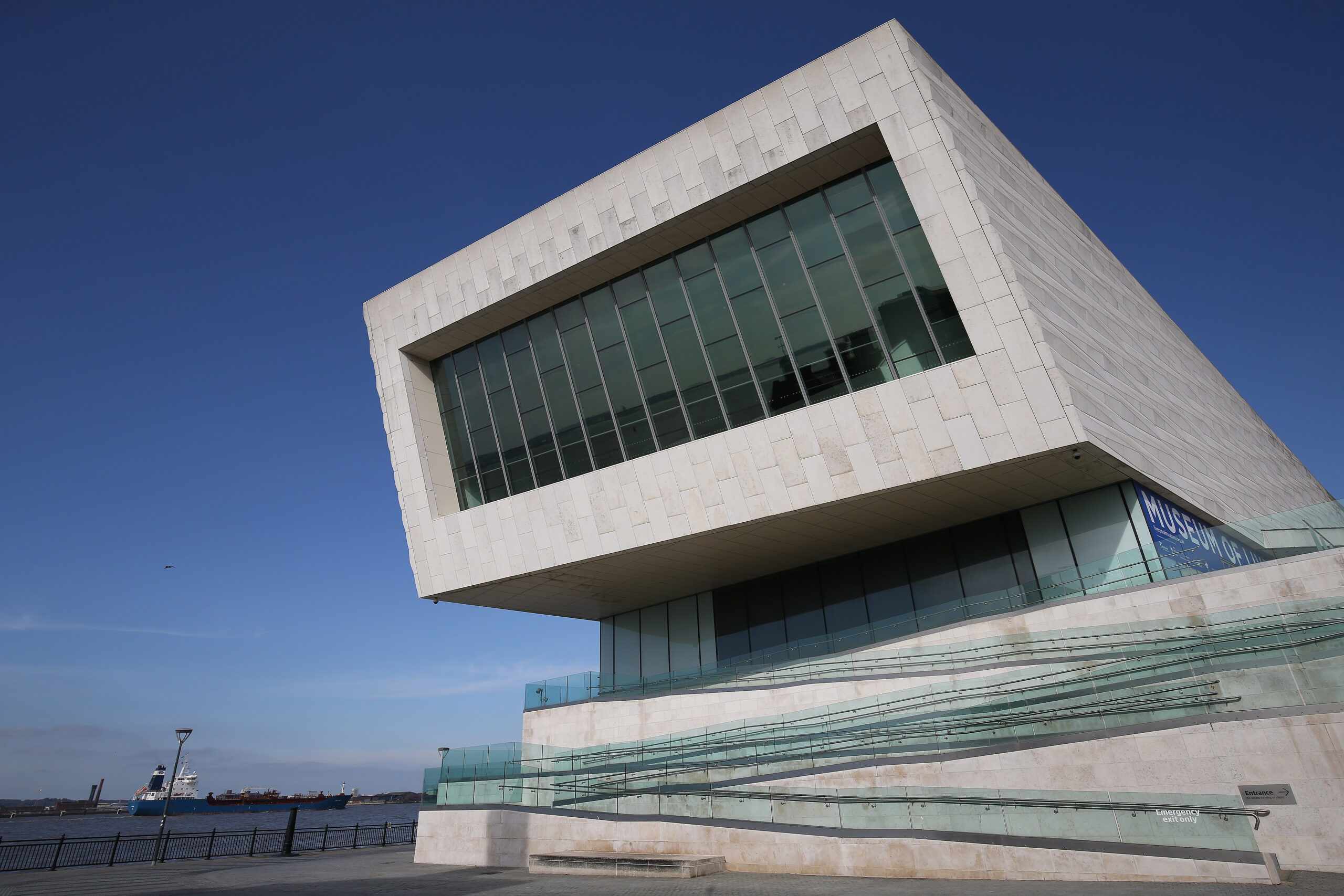 concrete exterior of the museum of liverpool against blue sky